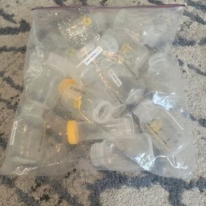 Bags of Medela milk bottles and parts